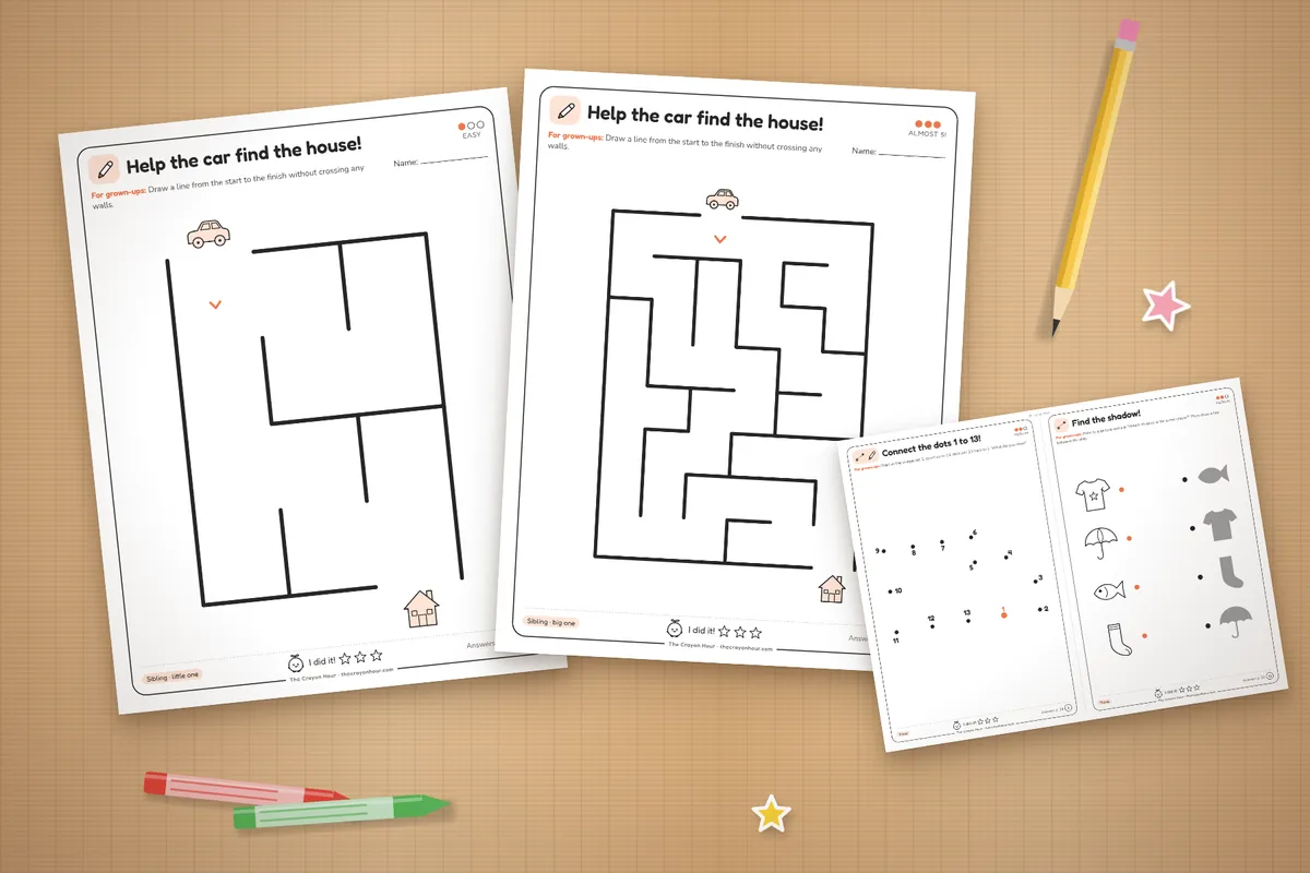 Printed maze and activity pages on a table with crayons and a pencil